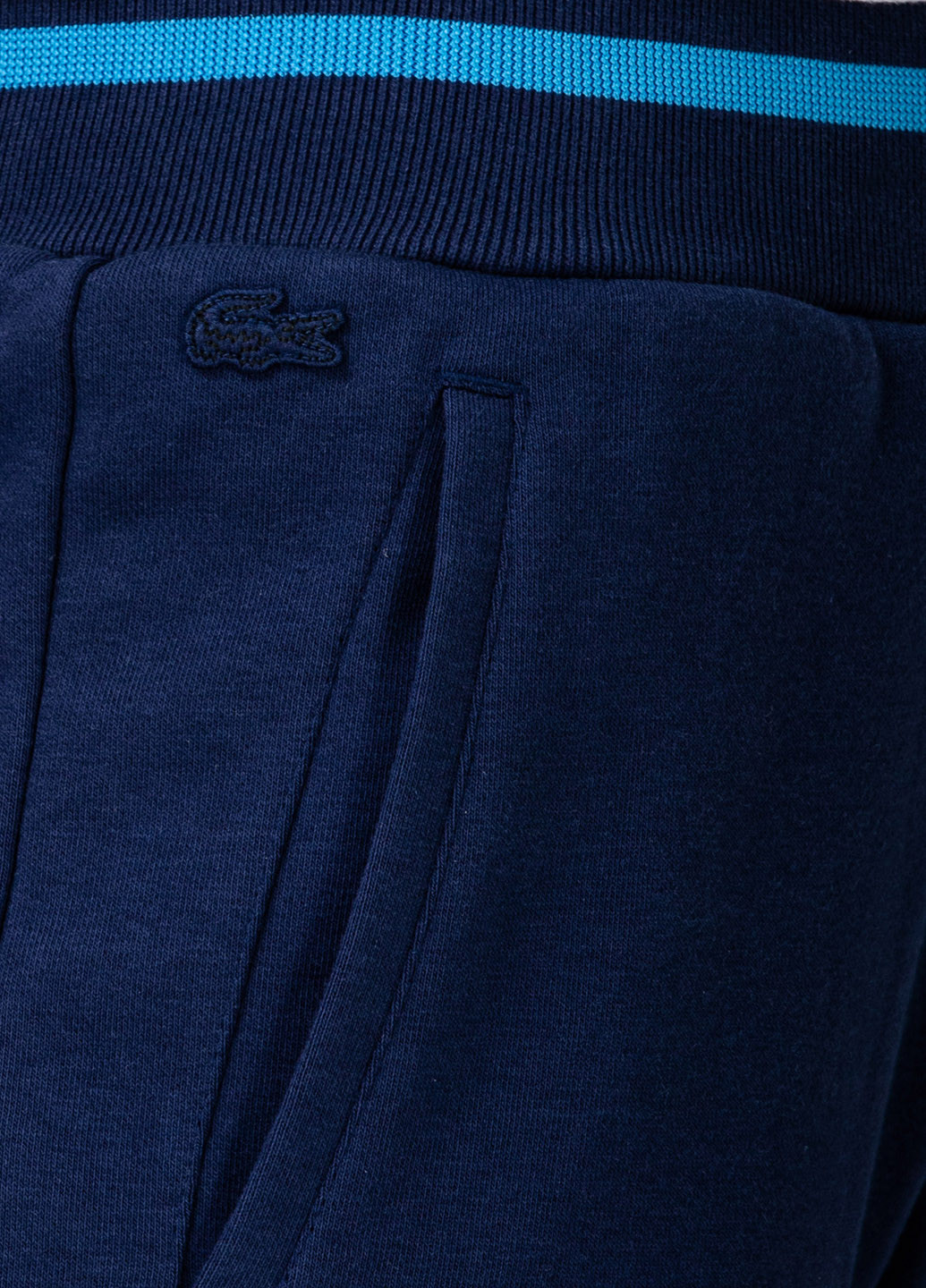 Темно-синие спортивные демисезонные укороченные, зауженные брюки Lacoste