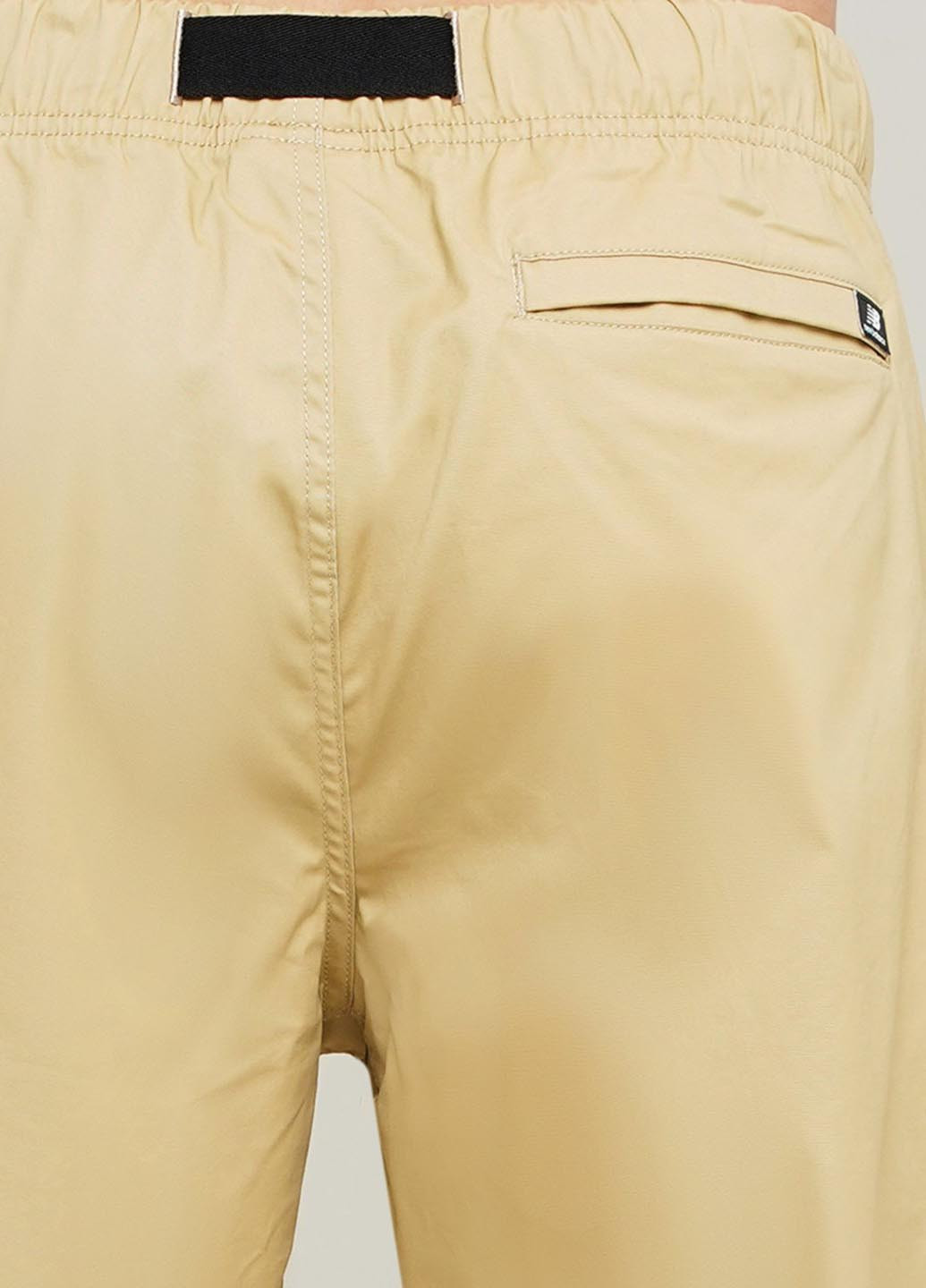 Желтые спортивные демисезонные зауженные брюки New Balance