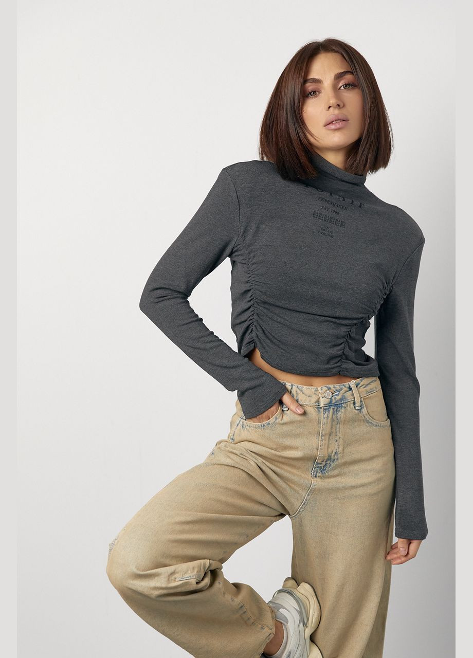 Трикотажний жіночий гольф з драпіруванням та написами - коричневий Lurex (317233674)