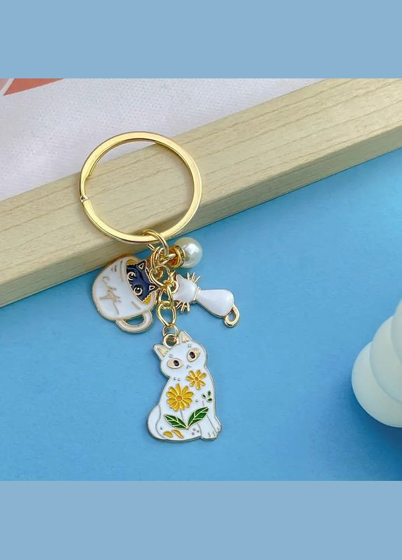 Брелок золотистий з підвісками котики LuxAurum305 Liresmina Jewelry (347151311)