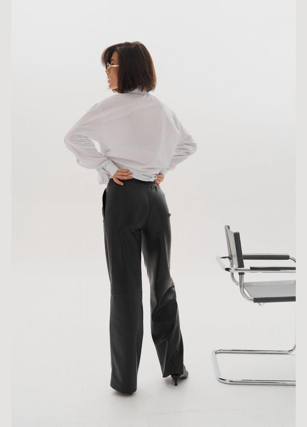 Женские брюки палаццо из эко кожи цвет черный р.L 450866 New Trend (282927974)