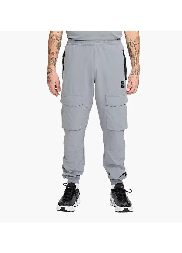 Серые демисезонные брюки Nike