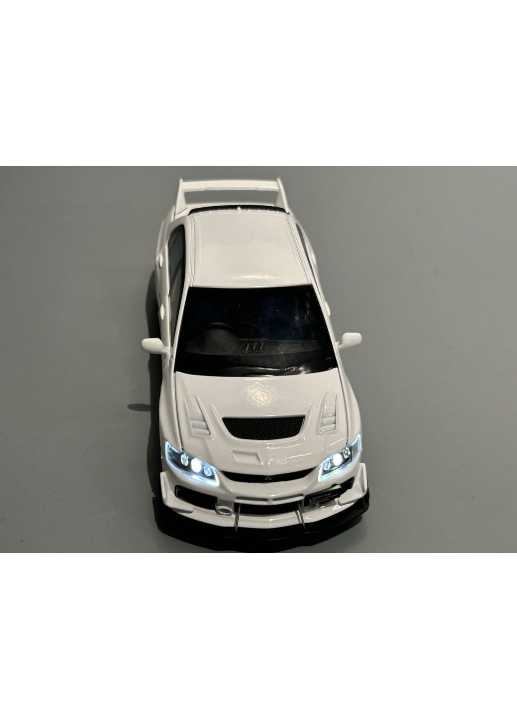 Машинка металлическая Авто Эксперт Mitsubishi Lancer Evo 1:32 открываются двери капот багажник свет/звук Белая (82501) No Brand (371646998)