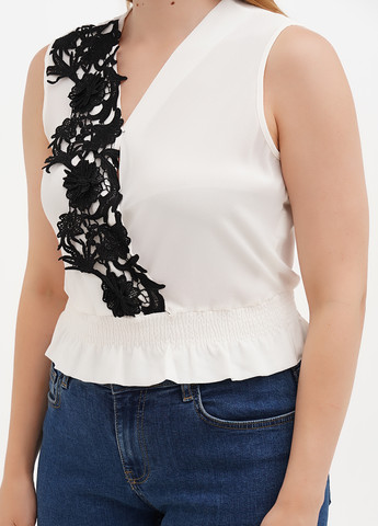 Молочна блуза з баскою Sassofono Club