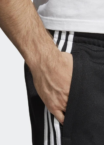 Черные спортивные демисезонные зауженные брюки adidas