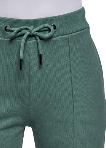 Оливково-зеленые спортивные демисезонные зауженные брюки Oodji