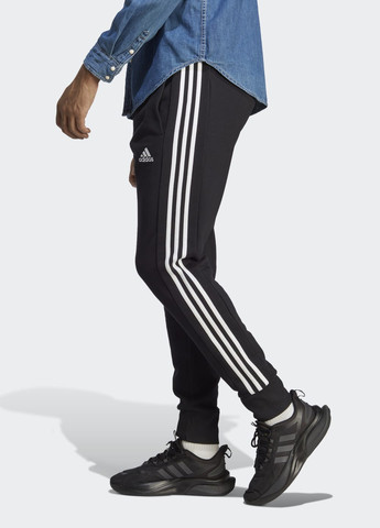 Штани Essentials French Terry Tapered Cuff 3-Stripes adidas (276839126)