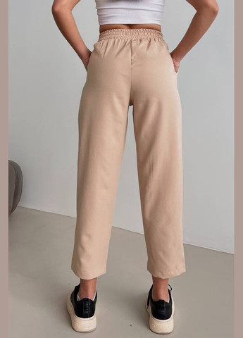 Штани жіночі бежевого кольору Let's Shop (292755180)