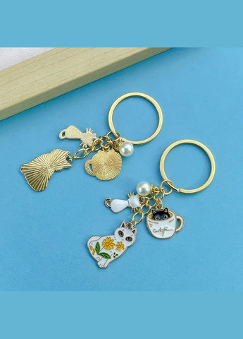 Брелок золотистий з підвісками котики LuxAurum305 Liresmina Jewelry (347151311)